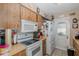 Bright kitchen featuring updated appliances, tiled floors, and plenty of storage at 12250 Lacey Dr, New Port Richey, FL 34654