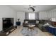 Cozy living room featuring a sectional sofa, ceiling fan, and neutral decor at 12250 Lacey Dr, New Port Richey, FL 34654