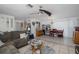 Spacious living room featuring a plush gray sofa and a cozy seating area at 12250 Lacey Dr, New Port Richey, FL 34654