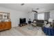 Comfortable living room with a large TV, modern fan, and natural light at 12250 Lacey Dr, New Port Richey, FL 34654