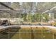 Shot of the screened-in swimming pool with patio and grill in the backyard of the residence at 12250 Lacey Dr, New Port Richey, FL 34654