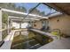 Well-maintained screened pool area, inviting relaxation with comfortable seating and serene outdoor ambiance at 12250 Lacey Dr, New Port Richey, FL 34654