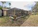 Spacious backyard pool area enclosed with a screen, offering a serene and private escape for relaxation and recreation at 12250 Lacey Dr, New Port Richey, FL 34654