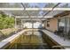 Screened-in swimming pool with patio and two storage sheds at this residence at 12250 Lacey Dr, New Port Richey, FL 34654