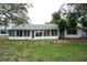Expansive screened-in porch at the back of the house, perfect for enjoying the outdoors in comfort at 12411 Yorktown Ln, Hudson, FL 34667
