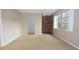 Spacious basement with large window, exposed brick accent wall, and access to additional rooms at 12411 Yorktown Ln, Hudson, FL 34667