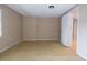 Open basement area with neutral walls and carpet, featuring access to other rooms in the house at 12411 Yorktown Ln, Hudson, FL 34667
