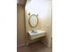 Ensuite vanity with large round mirror at 12411 Yorktown Ln, Hudson, FL 34667