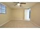 Empty bedroom with carpet flooring, neutral paint, and a window for natural light at 12411 Yorktown Ln, Hudson, FL 34667