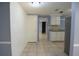 Open dining area showcasing a white brick accent wall and neutral tile flooring at 12411 Yorktown Ln, Hudson, FL 34667