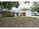Charming single-story home with a brick facade, well-manicured lawn, and an attached two-car garage at 12411 Yorktown Ln, Hudson, FL 34667
