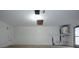 Spacious garage with white walls, concrete flooring and overhead door mechanics at 12411 Yorktown Ln, Hudson, FL 34667
