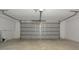 Spacious two car garage with white walls and concrete flooring at 12411 Yorktown Ln, Hudson, FL 34667