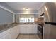Functional kitchen design featuring neutral countertops and modern appliances at 12411 Yorktown Ln, Hudson, FL 34667