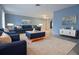 Beautiful living room with blue walls, contemporary furniture, and ample natural light at 12411 Yorktown Ln, Hudson, FL 34667