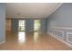 Light, bright living room with large windows, neutral walls and tiled floors at 12411 Yorktown Ln, Hudson, FL 34667