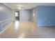 Spacious living room with light tile floors and neutral-toned walls at 12411 Yorktown Ln, Hudson, FL 34667