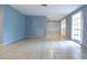 A spacious living room boasts neutral tile flooring, a large window, and fresh paint at 12411 Yorktown Ln, Hudson, FL 34667