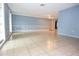 Spacious living room with light tile floors and neutral walls with white accents at 12411 Yorktown Ln, Hudson, FL 34667