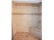 Walk-in shower with tiled walls, shower head, built-in seat, and mosaic tile accents at 12411 Yorktown Ln, Hudson, FL 34667