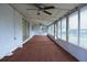 Enclosed sunroom with window-lined walls and ceiling fans for a bright, airy feel at 12411 Yorktown Ln, Hudson, FL 34667