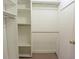Organized walk-in closet featuring built-in shelves and ample hanging space at 12411 Yorktown Ln, Hudson, FL 34667