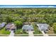 Aerial view of neighborhood with mature trees and well-manicured lawns at 13003 Sandburst Ln, Hudson, FL 34667