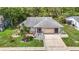 Overhead view of the single-story home with lush landscaping, mature trees, and an attached two-car garage at 13003 Sandburst Ln, Hudson, FL 34667