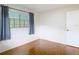 Bedroom featuring tile floors, a large window with gray curtains and a white door at 13003 Sandburst Ln, Hudson, FL 34667