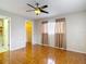 Bedroom with neutral tones, wood-look flooring, closet, and easy access to the ensuite bathroom at 13003 Sandburst Ln, Hudson, FL 34667