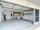 Spacious garage with washer/dryer hookups, work space, and painted floor at 13003 Sandburst Ln, Hudson, FL 34667
