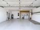 Large garage with a full laundry area, wash sink, and storage shelving at 13003 Sandburst Ln, Hudson, FL 34667