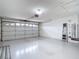 Well-lit two car garage with plenty of space for parking and storage at 13003 Sandburst Ln, Hudson, FL 34667