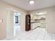 Open concept kitchen with white cabinets and adjacent dining area, perfect for entertaining at 13003 Sandburst Ln, Hudson, FL 34667