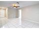 Spacious living room with tile flooring, neutral paint, and a ceiling fan for added comfort at 13003 Sandburst Ln, Hudson, FL 34667