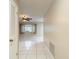 Bright living room with tile flooring, a ceiling fan and neutral wall paint at 13003 Sandburst Ln, Hudson, FL 34667