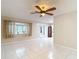 Sunlit living room boasting tile flooring, a ceiling fan, and a window that lets in ample natural light at 13003 Sandburst Ln, Hudson, FL 34667
