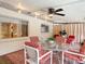 Cozy patio area with a glass table, chairs, and a view to outdoor space, creating a relaxing retreat at 13003 Sandburst Ln, Hudson, FL 34667