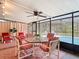 Enclosed patio with a ceiling fan, outdoor seating, and view of the refreshing swimming pool at 13003 Sandburst Ln, Hudson, FL 34667
