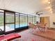 Enclosed patio with a view of the swimming pool, furnished with an outdoor dining set and comfortable lounge chairs at 13003 Sandburst Ln, Hudson, FL 34667
