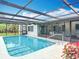 Sparkling pool with a screened enclosure, offering a private oasis for relaxation and recreation at 13003 Sandburst Ln, Hudson, FL 34667