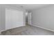 Carpeted bedroom features a large closet with folding doors and a neutral color palette at 13343 Sampson Ave, Brooksville, FL 34614