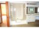 A full bathroom features a tiled shower and large vanity at 13425 Bonita Ave, Spring Hill, FL 34609