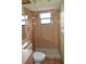 Bathroom with a walk-in shower featuring tiled walls and a shower head at 13425 Bonita Ave, Spring Hill, FL 34609