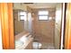 Bathroom with walk-in shower, toilet and sink at 13425 Bonita Ave, Spring Hill, FL 34609
