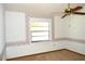 Bedroom with neutral carpet, floral wallpaper border, ceiling fan, and one window at 13425 Bonita Ave, Spring Hill, FL 34609