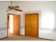 Bedroom with floral wallpaper accents, ceiling fan, and a closet at 13425 Bonita Ave, Spring Hill, FL 34609