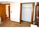 View of bedroom featuring an open bi-fold closet with shelving and adjacent doorway at 13425 Bonita Ave, Spring Hill, FL 34609