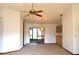 View of the dining room with ceiling fan and lighting, built-in cabinets, and sliding glass doors at 13425 Bonita Ave, Spring Hill, FL 34609