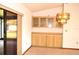 Dining room features built-in cabinets and countertop, chandelier, and sliding doors at 13425 Bonita Ave, Spring Hill, FL 34609